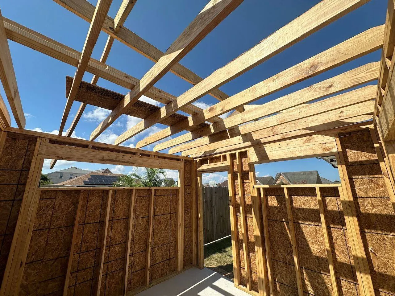 Interior framing with rafters and OSB sheathing during new construction shed build in Meraux Louisiana