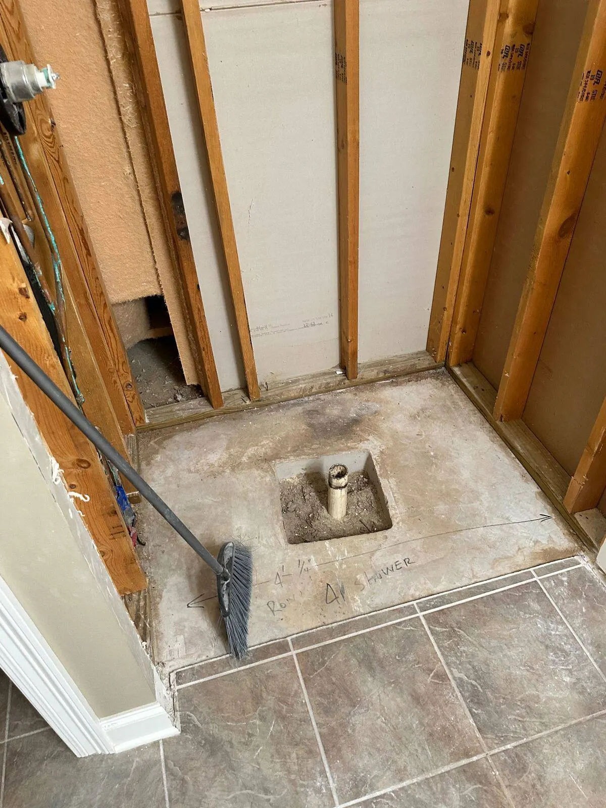 Shower drain and plumbing rough-in during bathroom renovation