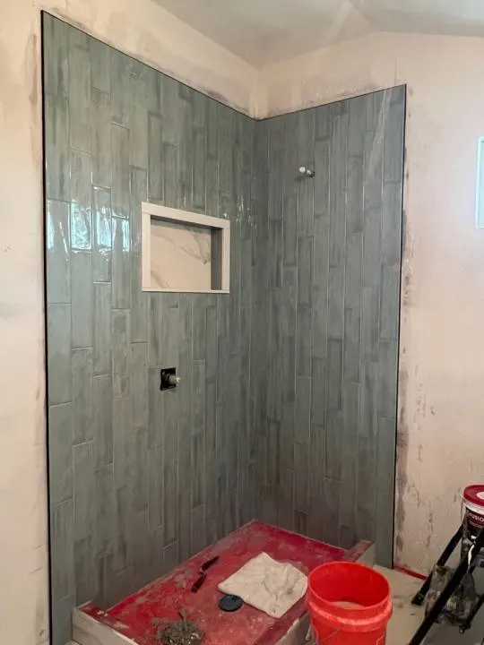 Custom green tile shower installation for second floor addition in Metairie Louisiana