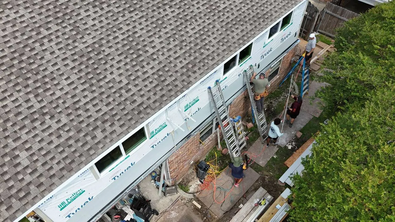 Vinyl siding and window installation on a second-story addition in Metairie, Louisiana