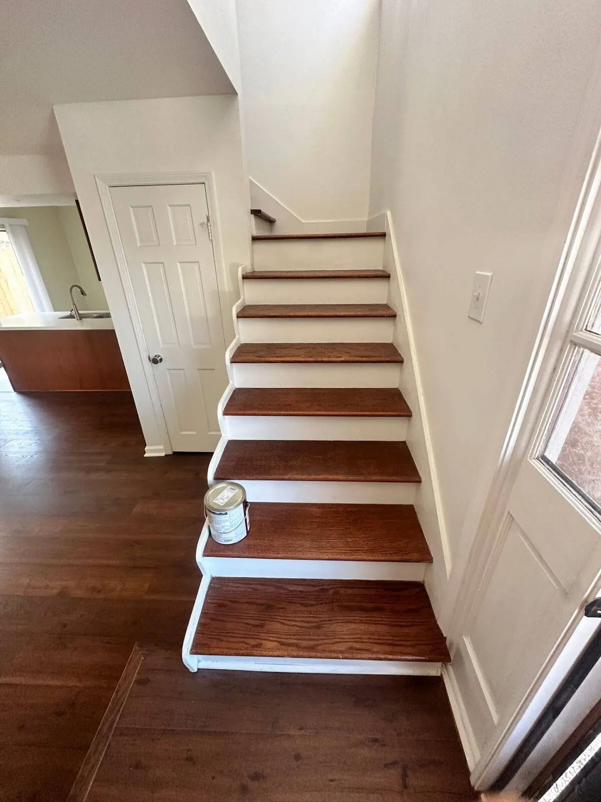 Custom staircase renovation with hardwood treads and white risers in Covington LA