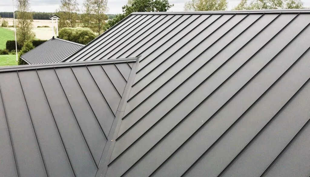 Aerial view of a dark charcoal standing seam metal roof showing clean vertical panel lines and concealed fasteners