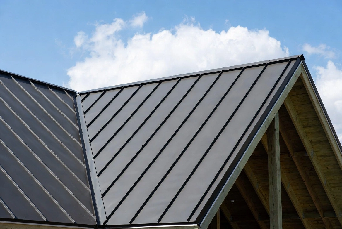 Standing seam metal roof installation on residential home