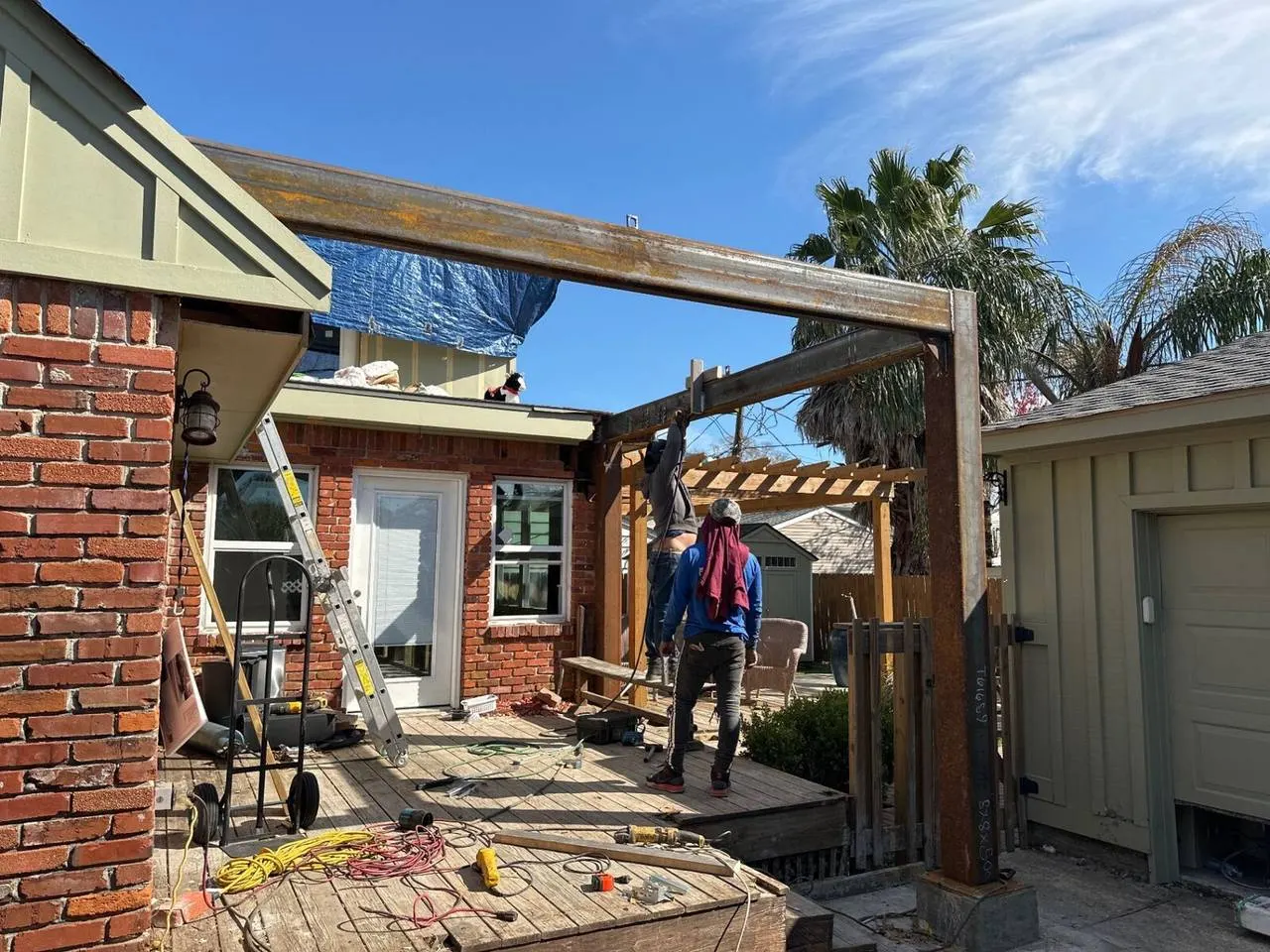 Structural steel beam installation during home addition project in Metairie