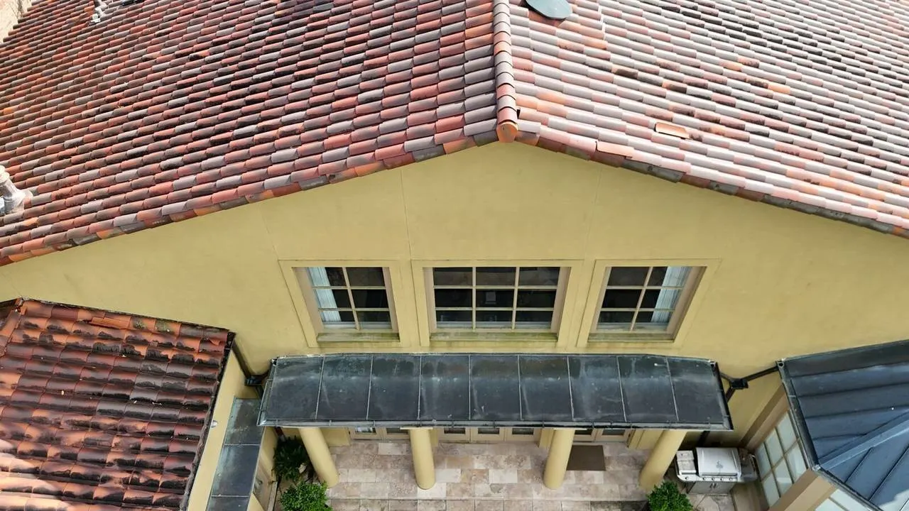 Stucco exterior with clay tile roof on an Old Metairie home