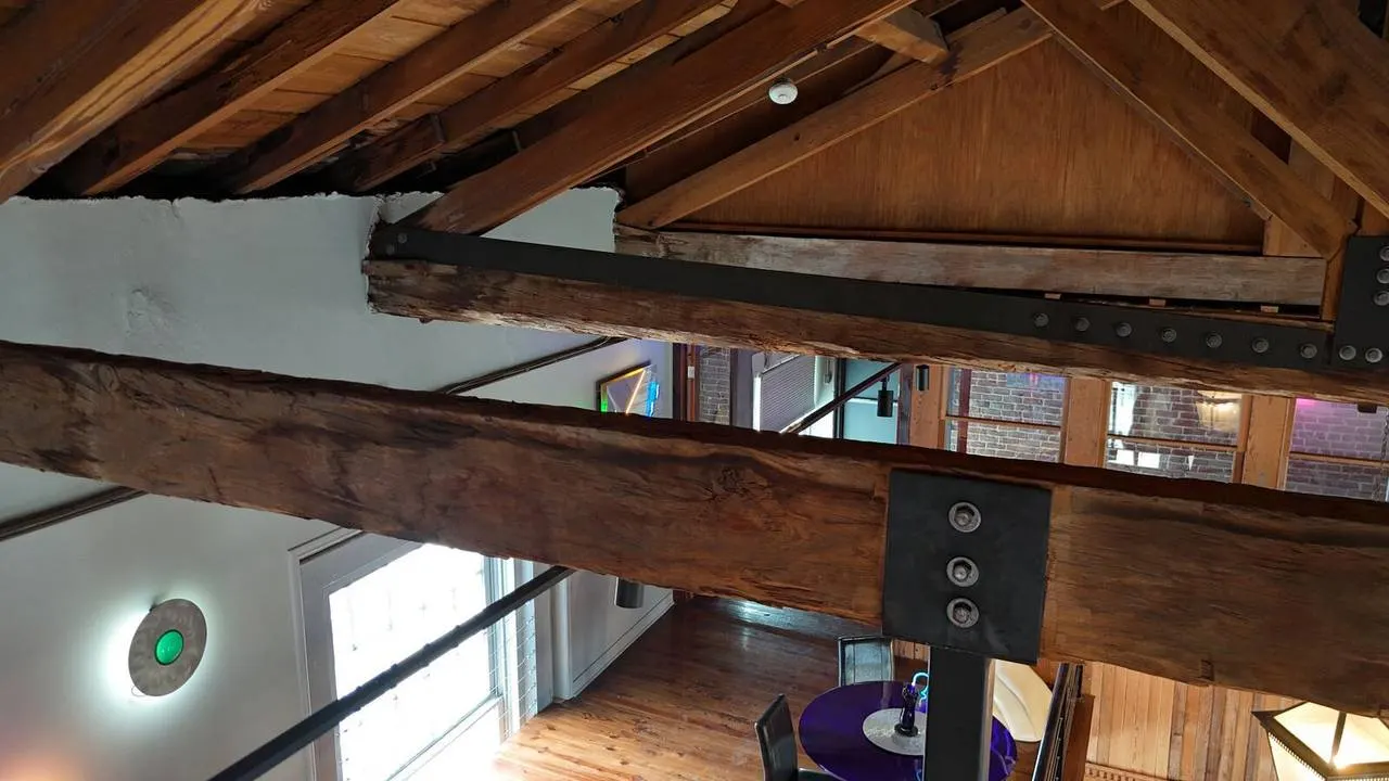 Steel beam reinforcement of historic wood beams in Vieux Carré structural restoration project