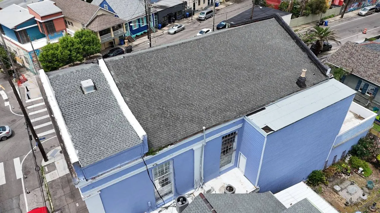 Aerial view of historic Vieux Carré building restoration with shingle roof in New Orleans French Quarter