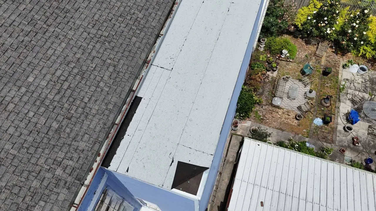 Aerial view of flat roof and shingle roof restoration on historic French Quarter property