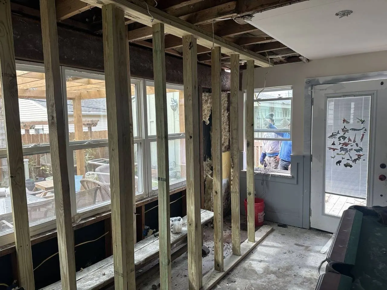 Structural wall framing repair with new treated lumber studs and header installation in Gretna home