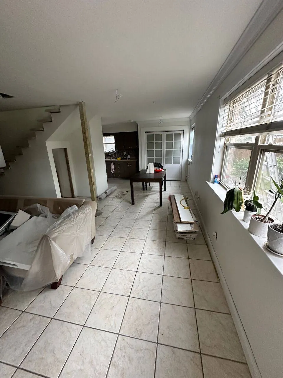 Living room before renovation with old tile flooring in New Orleans home